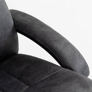 Detail of the curved padded armrest meeting the thick seat cushion
