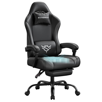 Ink black and slate grey synthetic leather gaming chair with footrest, studio shot