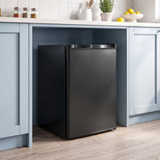 Compact freezer fitted under a kitchen worktop between cupboards