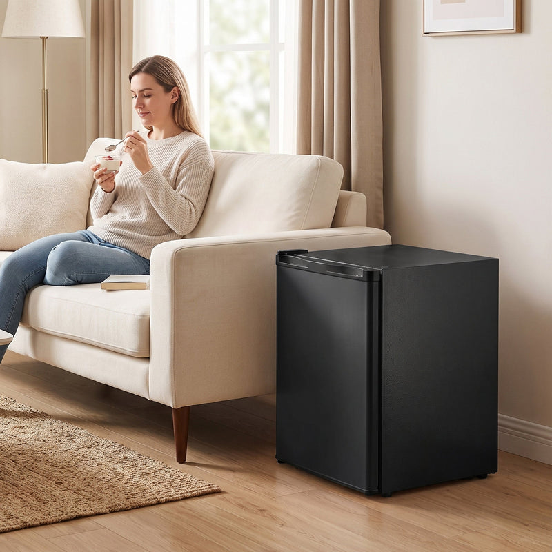 Woman eating ice cream on a sofa with the mini freezer beside her