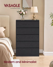 Black 5 drawer chest beside a bed with a lamp and flowers on top
