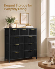 Black 9-drawer corduroy chest styled in a living room beside a sunny window