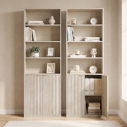 Two oak bookcases side by side, one with cabinet door open