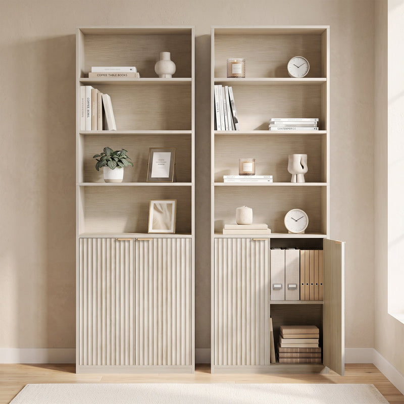 Two oak bookcases side by side, one with cabinet door open