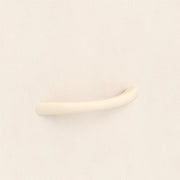 Close-up of the beige drawer handle on the fabric