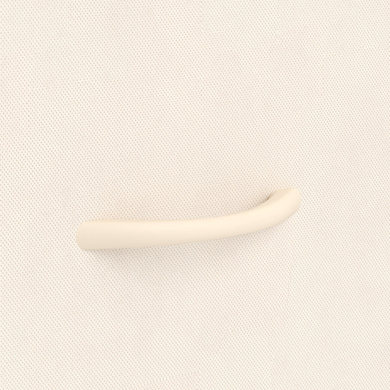 Close-up of the beige drawer handle on the fabric