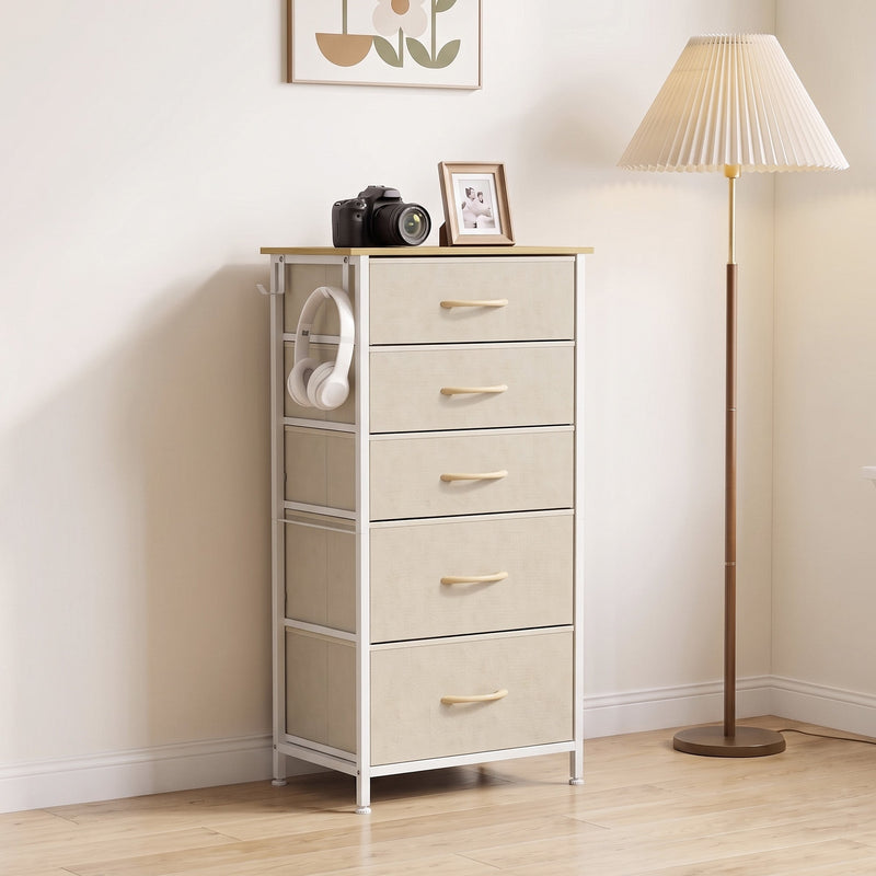 Beige fabric chest of drawers in a living room beside a floor lamp