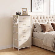 Fabric chest of drawers with headphones on the side hook beside a bed, shown in beige