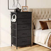 Tall chest beside a tufted bed with a camera on top and headphones on the hook, shown in black