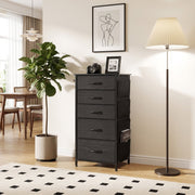 Chest of drawers in a dining area next to a fig tree and floor lamp, shown in black