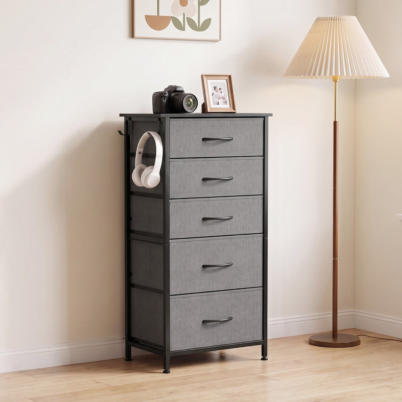 Chest of drawers beside a floor lamp with headphones on the side hook, shown in grey