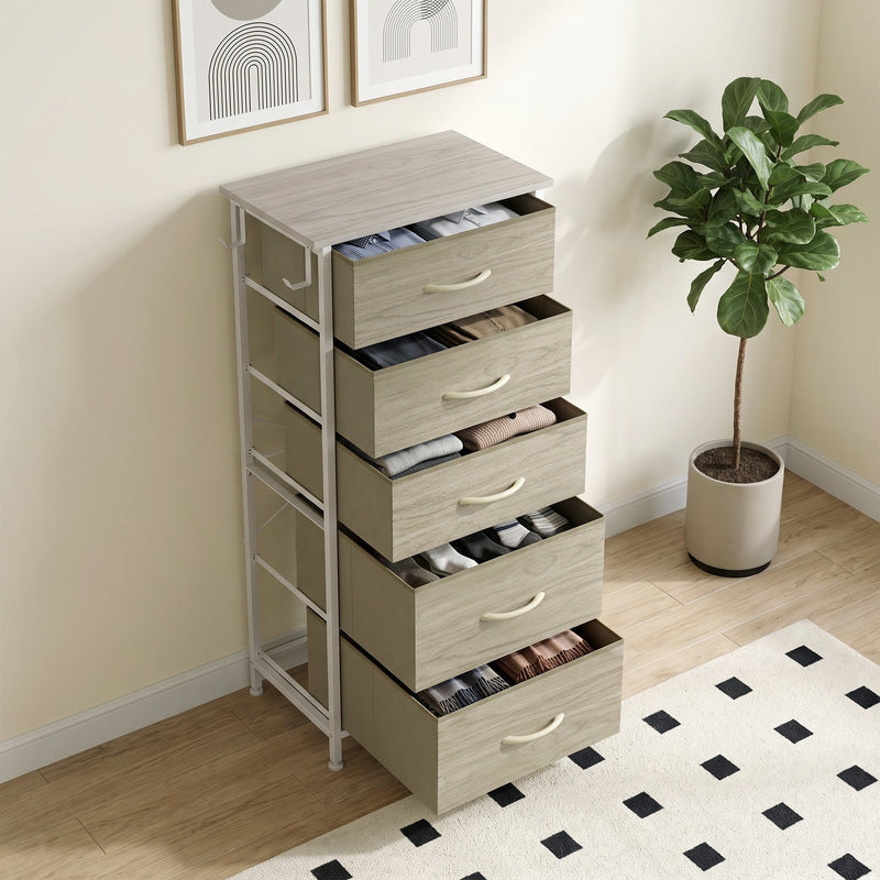 Angled view of the chest with drawers open beside a potted plant, shown in oak