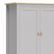 Close-up of the grey cupboard doors with tan pulls and wood-effect top