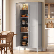 Grey pantry cupboard with open doors showing lit, stocked shelves beside a dining table