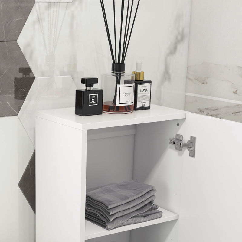Open cupboard door showing a shelf with folded grey towels and toiletries on top