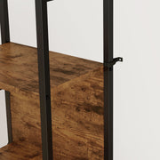 Close-up of an anti-tip strap fixed to the steel frame beside a wooden shelf