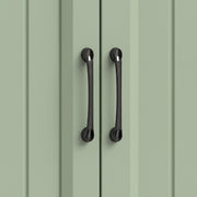 Close-up of the black handles on the sage green beadboard cupboard doors