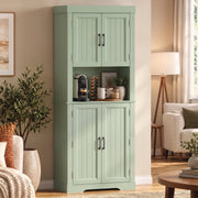 Sage green tall kitchen cupboard in a living room beside a floor lamp and potted plants