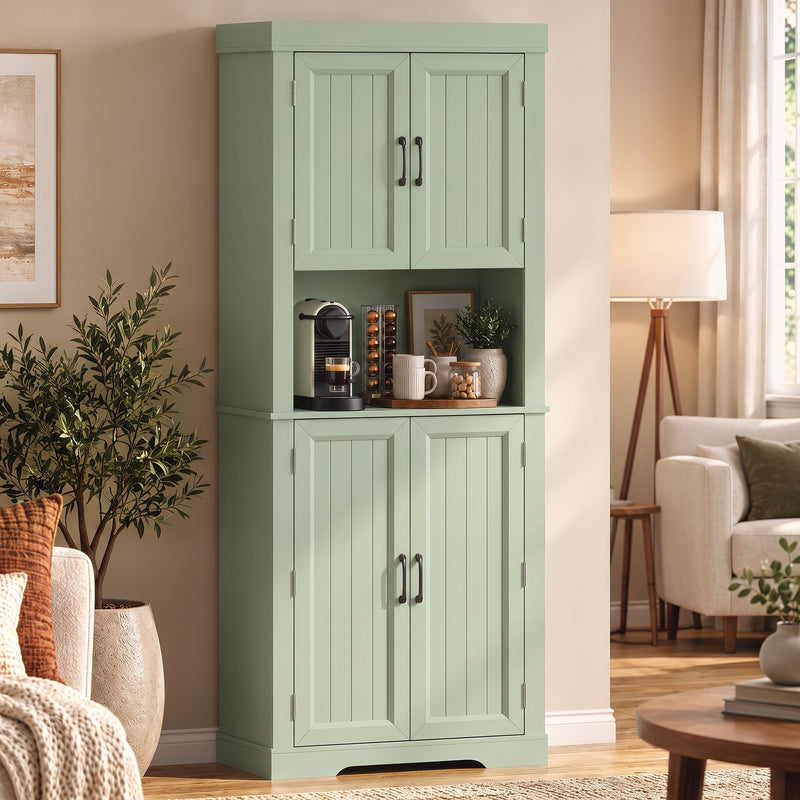 Sage green tall kitchen cupboard in a living room beside a floor lamp and potted plants