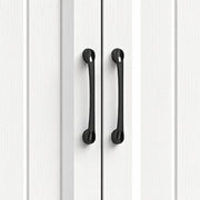 Close-up of the black handles on the white beadboard cupboard doors