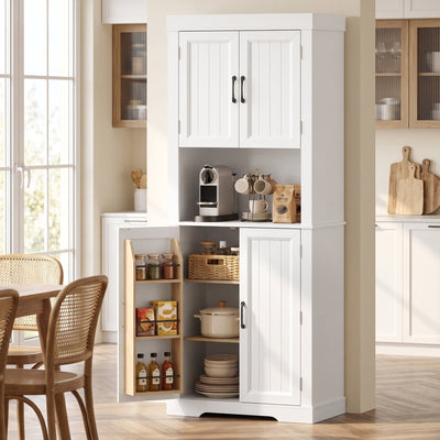 White tall kitchen cupboard in a dining room with a lower door open to show spice racks