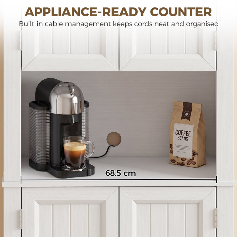 Open countertop compartment of the white cupboard holding a coffee machine, labelled 68.5 cm wide