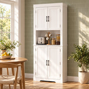White tall kitchen cupboard against a green tiled wall with a toaster and jars on the open counter
