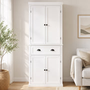 White kitchen cupboard styled beside a sofa in a living room setting