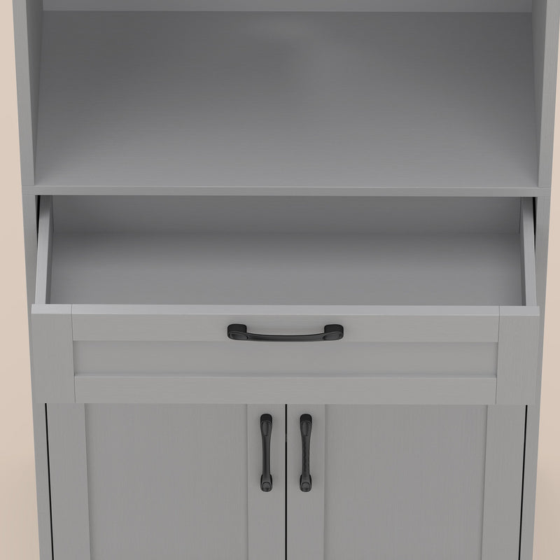 Close-up of the open drawer and black handles on the grey pantry