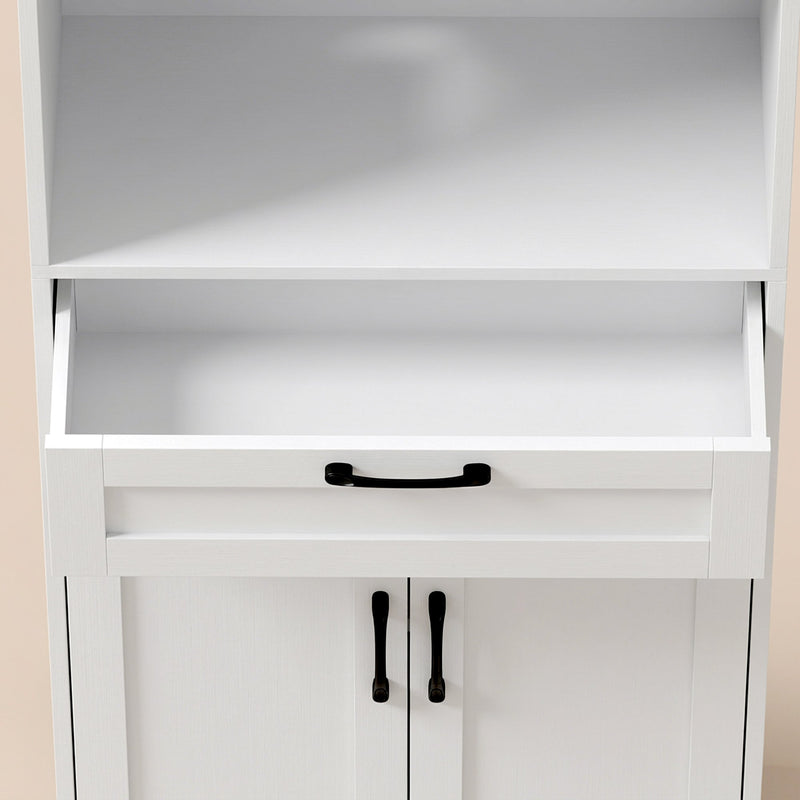 Close-up of the open drawer and black handles on the white pantry