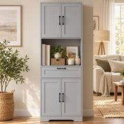 Grey pantry in a living space beside plants and a floor lamp