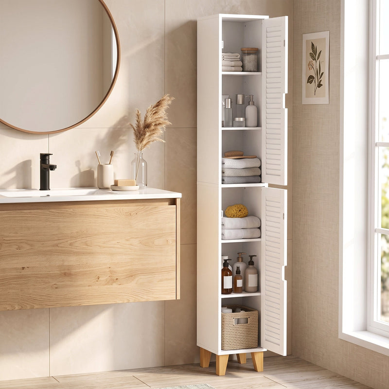 Tall white cabinet beside a wall-hung vanity and round mirror, stocked with towels and toiletries