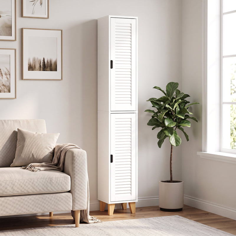 Tall white cabinet in a living room beside a sofa and fiddle-leaf plant