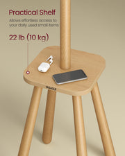 Close-up of the coat rack shelf holding a phone and earbuds, showing 10 kg shelf capacity