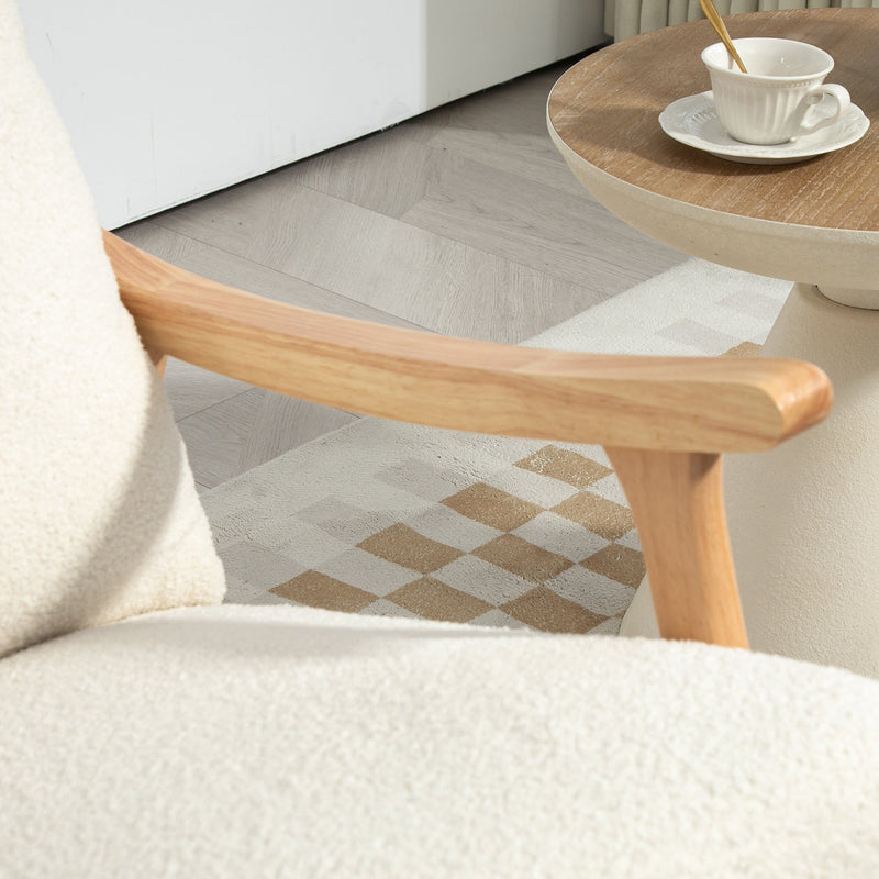Close-up of the wooden armrest and teddy fleece seat of the cream white rocking chair