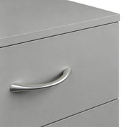 Close-up of a silver aluminium handle on a grey drawer front