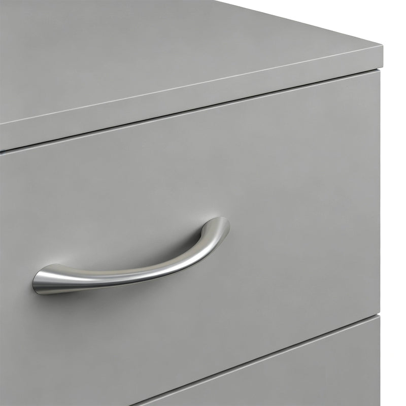 Close-up of a silver aluminium handle on a grey drawer front
