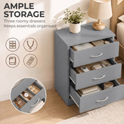 Grey bedside table with all three drawers open showing stored books, accessories and notes