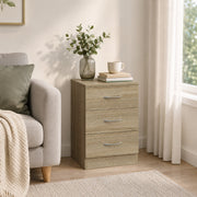 Bedside table used beside an armchair with a vase and books on top