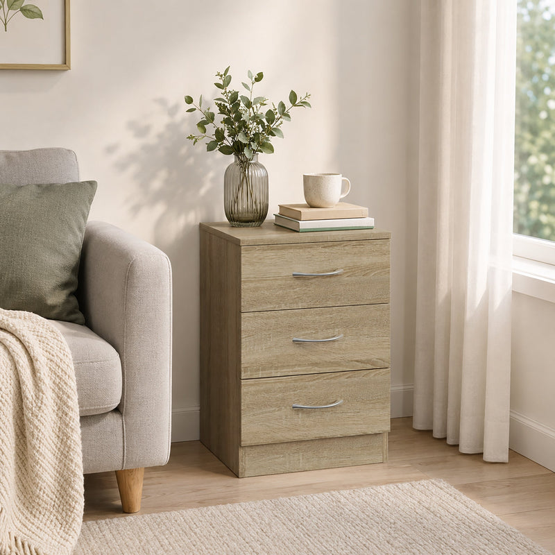 Bedside table used beside an armchair with a vase and books on top