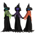 Three Homcom Halloween witches holding hands in green, purple and orange scarves, studio shot