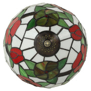 Top-down close-up of the red floral stained glass shade with green leaves