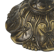 Close-up of the ornate bronze-tone lamp base