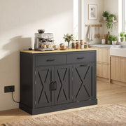 Black tilt out trash cabinet styled as a kitchen island with a coffee maker and crockery on the worktop