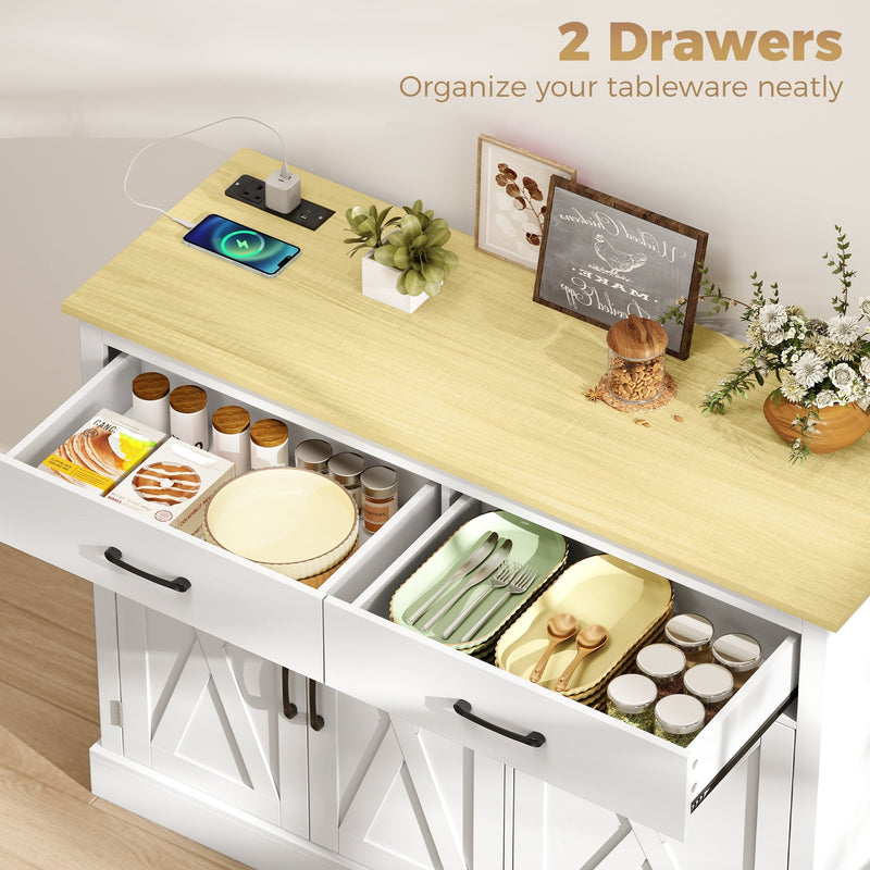 Open drawers of the white cabinet storing plates, cutlery trays and spice jars on the kitchen worktop