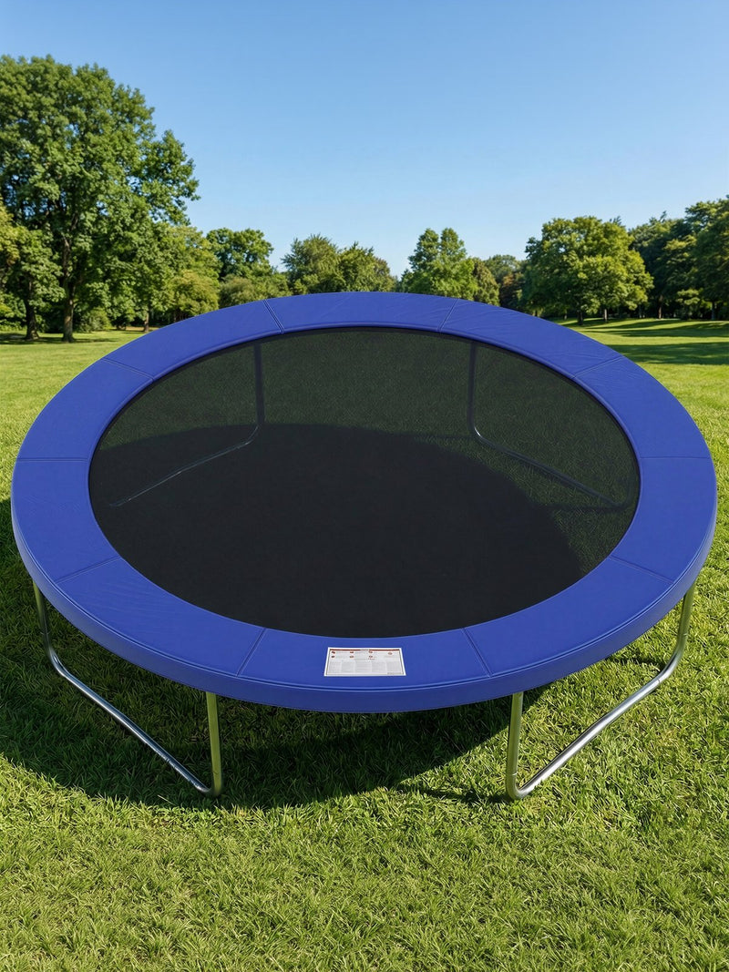 Blue safety pad fitted to a round trampoline frame standing on grass in a park