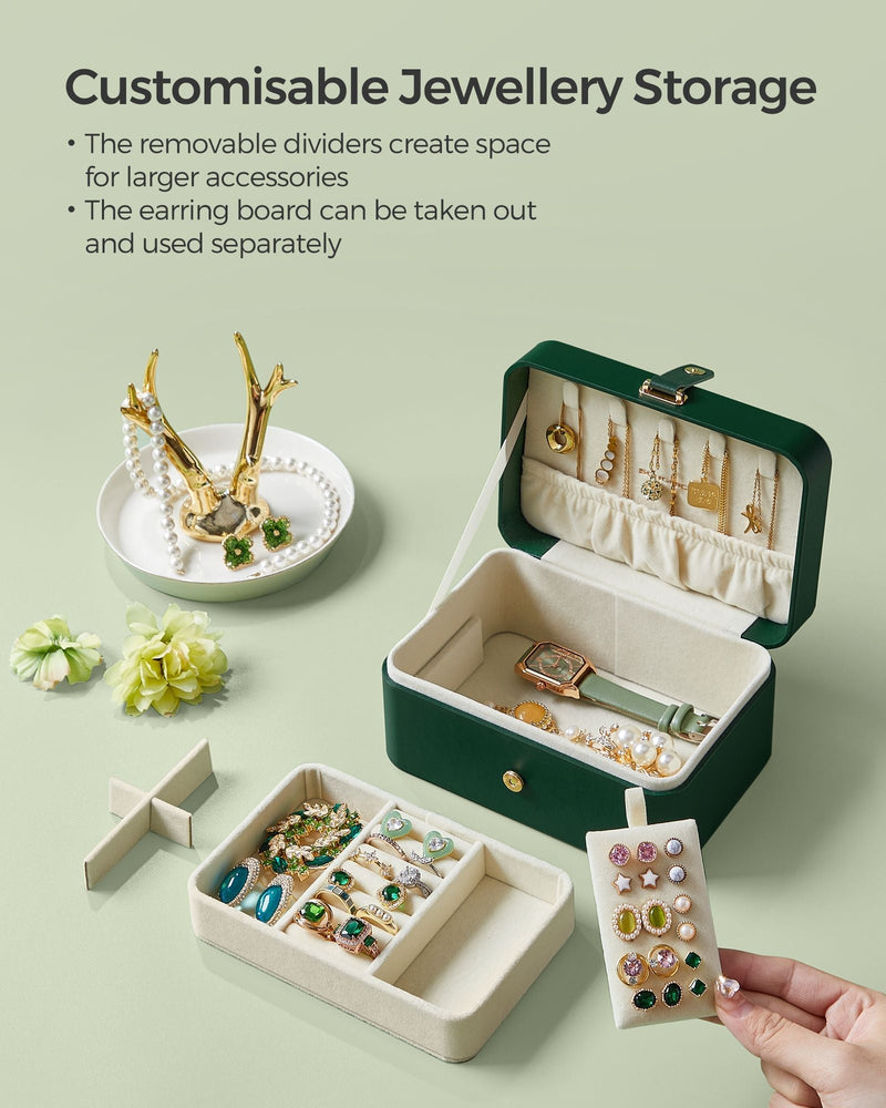 Open case beside rings and earrings, showing the removable dividers and detachable earring board