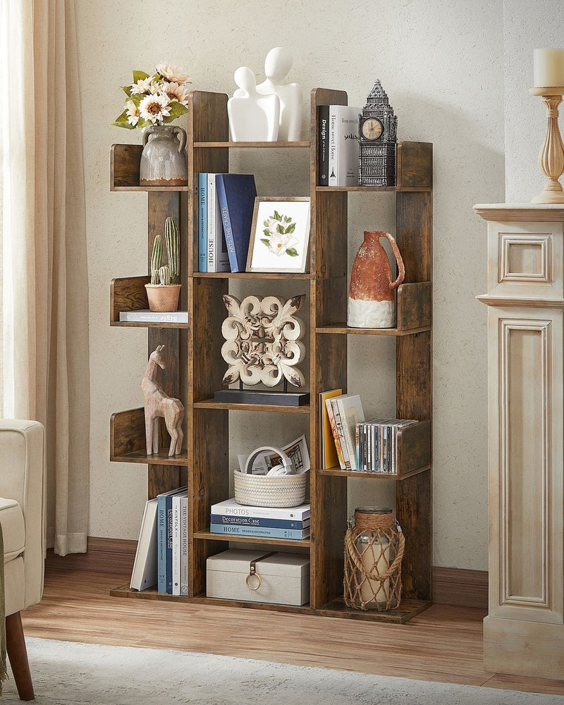 Tree bookshelf in a living room beside a fireplace holding books, vases and figurines
