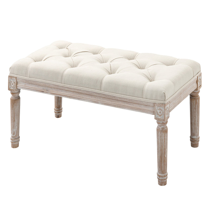 Cream tufted bench with wooden legs shown from a three-quarter angle on a white background