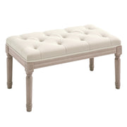Cream white button-tufted bench with distressed wooden legs on a white background